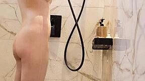 Bathing black-haired Japanese girl with ponytail and small tits