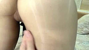 She enjoys passionate sex through a pantyhose hole and gives a blowjob.