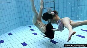 shaved brunette babe with big tits teases subtly in underwater pool bathing session with tight body