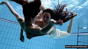 shaved brunette babe with big tits teases subtly in underwater pool bathing session with tight body