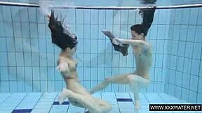 shaved brunette babe with big tits teases subtly in underwater pool bathing session with tight body