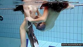 shaved brunette babe with big tits teases subtly in underwater pool bathing session with tight body