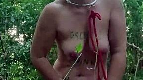 Slave maid in bondage gets handcuffed and fucked doggystyle with dildo in public outdoor humiliation.