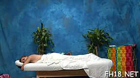 beautiful young woman gets a thorough massage from her skilled rubber. she enjoys the relaxing session outdoors.