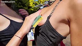 Brunette and redhead enjoy a passionate bike wash with kissing and outdoor lesbian licking.