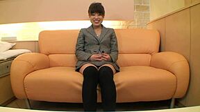 japanese teen explores intimate moments on bed in fishnets and lingerie