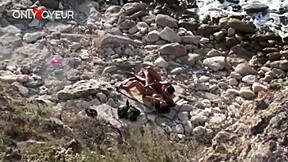 Beach voyeur watches young tanned couple having outdoor fun