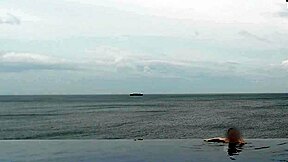 skinny japanese girl chills by infinity pool