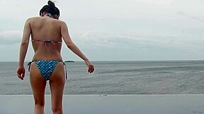 skinny japanese girl chills by infinity pool