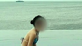 skinny japanese girl chills by infinity pool